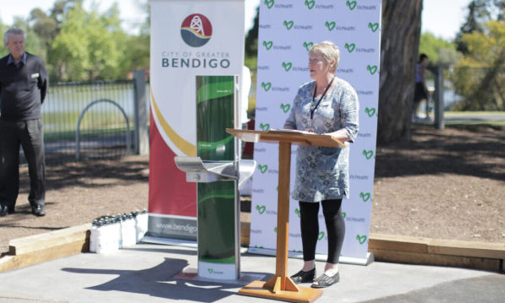 Maree Edwards giving speech on Greater Bendigo Community beside next to Aquafil FlexiFountain 1500BFF Drinking Fountain and Water bottle refill station