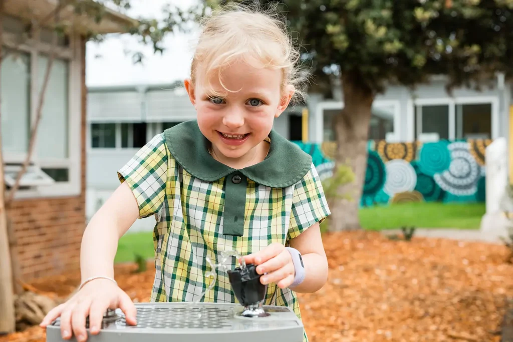 a student from Cronulla Public School enjoying her drink from their newly installed Aquafil Solo Drinking Fountain from Civiq as their sustainability goals