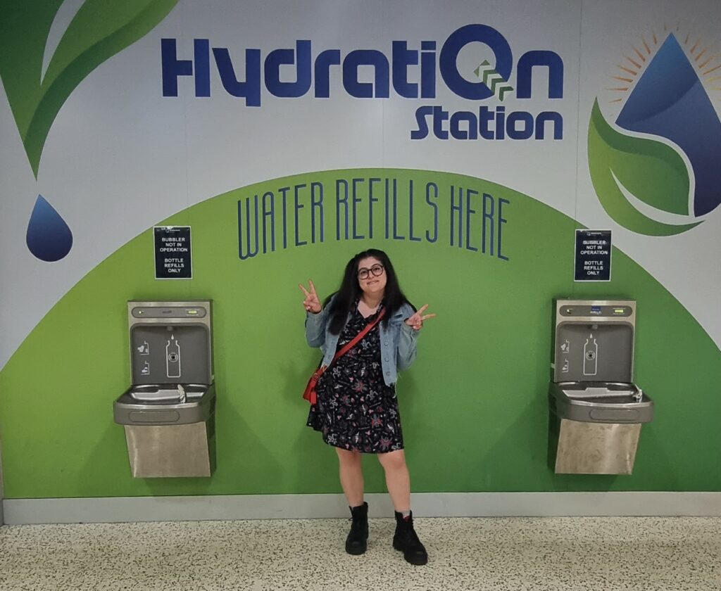 One of the arena concert goer posting between two Elkay EZH2O Drinking Fountain and Water Bottle Refilling Stations