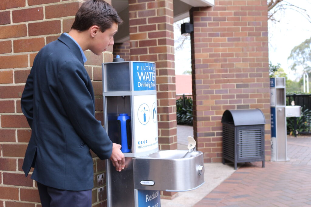 a student from Knox Grammar School refilling his water bottle at an Aquafil drinking water station