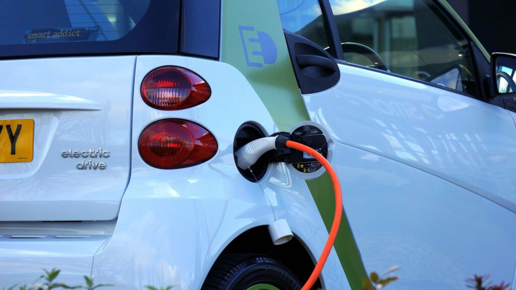 A sleek electric vehicle seamlessly connects to a charging station, symbolizing eco-friendly transportation and the shift towards sustainable energy solutions.